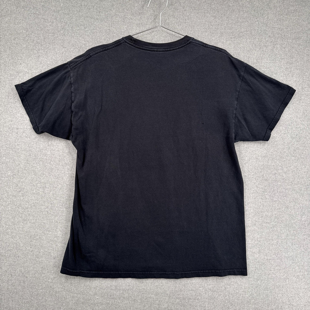 Black t-shirt on a hanger against a gray background