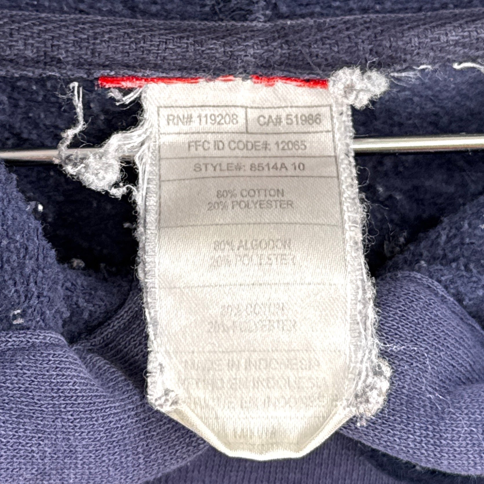 Clothing label on a blue fabric background