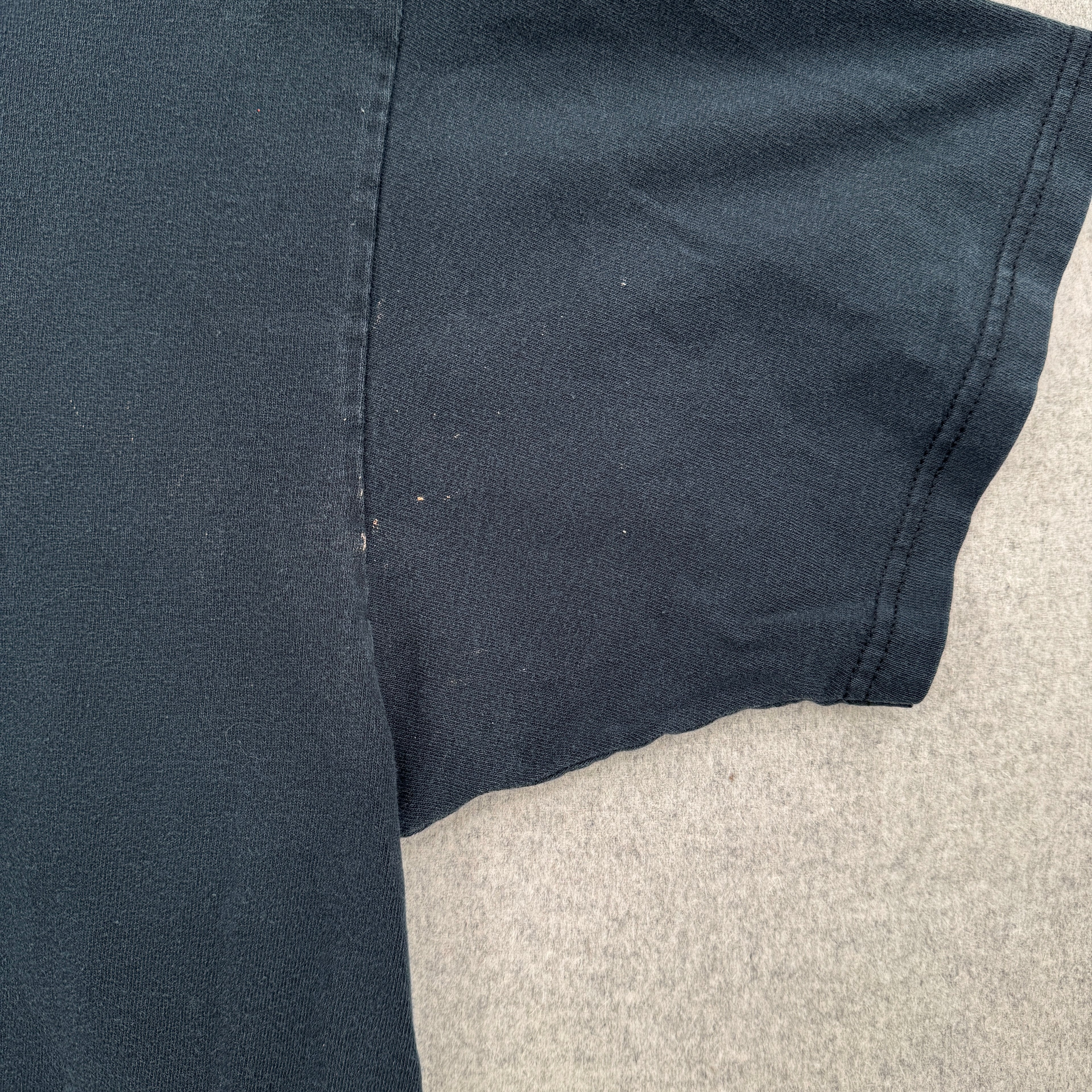 close up of the sleeve/armpit area. shows a few small stain spots