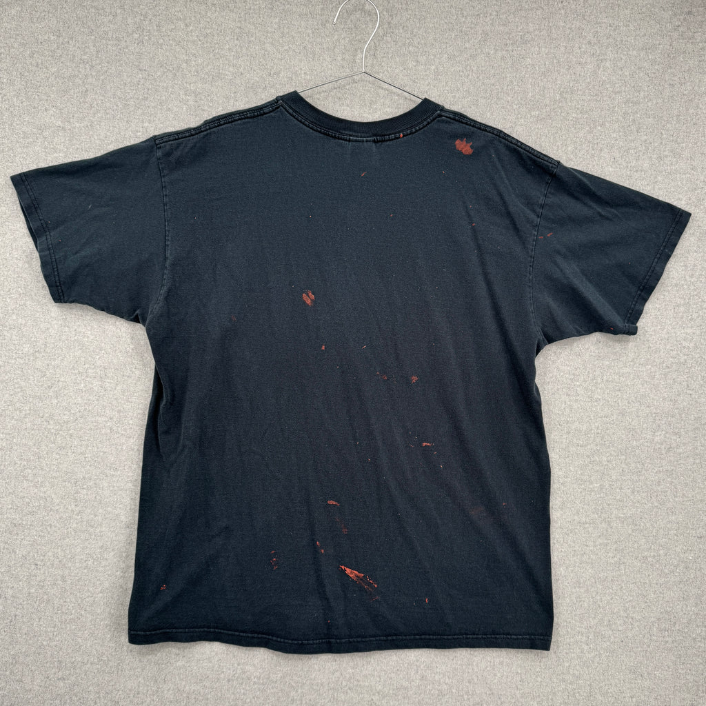 back of black tee shirt showing multiple red splatter stain spots